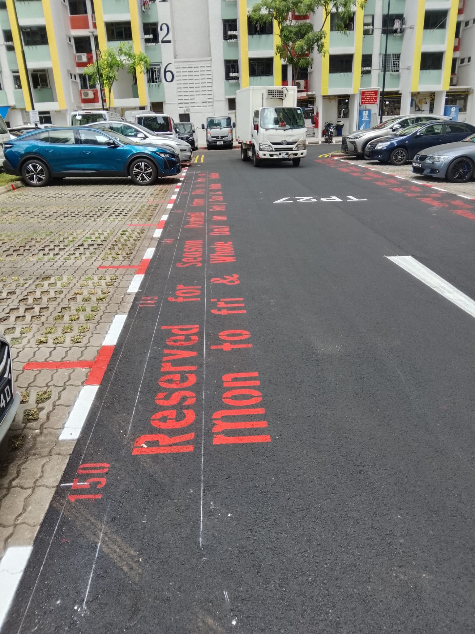 Completed carpark line marking with reserved lot signage and directional arrows by EMK Construction